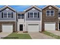 Two-story townhome with gray and brown siding, and two-car garage at 719 Wagon Cross Ct, York, SC 29745