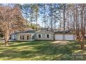 Ranch home with attached three-car garage and large yard at 8940 Mcilwaine Rd, Huntersville, NC 28078