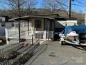 Quaint lakefront cottage with a deck and covered patio at 168 Clubhouse Dr, New London, NC 28127