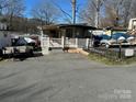Small cottage with a deck and ramp, nestled in a lakeside community at 168 Clubhouse Dr, New London, NC 28127