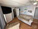 Lake-themed living room with comfy seating and large TV at 168 Clubhouse Dr, New London, NC 28127