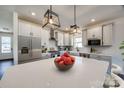 Modern kitchen featuring an island with quartz countertops, stainless steel appliances and stylish pendant lighting at 18011 Wilbanks Rd, Charlotte, NC 28278