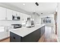 Modern kitchen with island, stainless steel appliances, and white cabinets at 1927 W Trade St, Charlotte, NC 28216