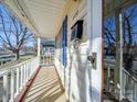 Inviting front porch with white railings overlooking the street at 230 Spring Nw St, Concord, NC 28025