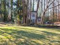 Two story house with gray siding, surrounded by trees at 410 Lakenheath Ln, Matthews, NC 28105