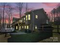 View of the back of the home with a large deck, and a fenced yard at 412 Wildlife Rd, Troutman, NC 28166