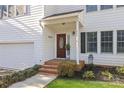Inviting front entrance with brick steps, a brown door, and tasteful landscaping at 5204 Sardis Rd, Charlotte, NC 28270
