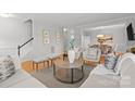 Open living space featuring hardwood floors, comfortable seating, and a view of the dining area at 5204 Sardis Rd, Charlotte, NC 28270