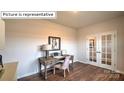 Spacious home office with double French doors and hardwood floors at 564 Zermatt Ct, Monroe, NC 28112