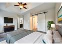Bright bedroom with a modern barn door, carpet flooring and ensuite bathroom at 634 Atherton Way, Rock Hill, SC 29730