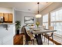 Modern dining room with concrete table, hardwood floors, and stylish lighting at 634 Atherton Way, Rock Hill, SC 29730