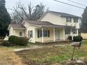 Two-story house with covered porch and mature trees at 724 Log Cabin Dr, Gastonia, NC 28054