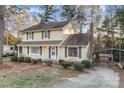 Two-story house with yellow siding, front porch, and landscaping at 9 Post Oak Pl, Salisbury, NC 28147