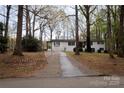 A view of the home from the street, highlighting the long driveway and front facade at 1035 Timberlane Dr, Lincolnton, NC 28092