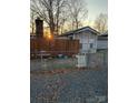 Mobile home with wooden fence and bird bath in front at 145 Arrowood Trl # 61F, Mount Gilead, NC 27306