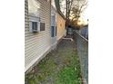Tan mobile home exterior with a side yard and chain link fence at 145 Arrowood Trl # 61F, Mount Gilead, NC 27306