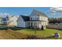 Gray house with white trim, landscaping, and a large yard at 235 Goldenrod Cir, Salisbury, NC 28147