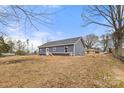 A tranquil backyard with a home featuring blue siding and white trim against a clear blue sky at 2365 28Th Ne St, Hickory, NC 28601