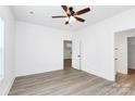 Well-lit bedroom boasts wood-look floors, a ceiling fan, and an adjacent closet with shelves at 2365 28Th Ne St, Hickory, NC 28601