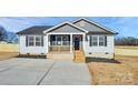 Newly built home with gray accents, white siding, and a wooden front porch at 2365 28Th Ne St, Hickory, NC 28601