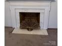 Fireplace with marble surround and brass screen at 319 N Peterson St, Stanley, NC 28164