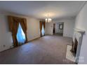Spacious living room featuring a fireplace and large windows at 319 N Peterson St, Stanley, NC 28164