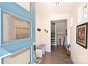 Bright and airy entryway with blue door and hardwood floors at 416 Wesley Heights Way, Charlotte, NC 28208
