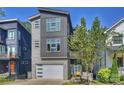 Modern three-story home with gray siding, white garage door, and blue front door at 416 Wesley Heights Way, Charlotte, NC 28208
