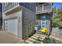 Modern home with light gray siding, blue door, and stone walkway at 416 Wesley Heights Way, Charlotte, NC 28208