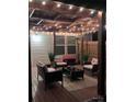 Nighttime view of a covered patio with stylish furniture and decorative string lights, creating a relaxing ambiance at 490 Melvista Ave, Rock Hill, SC 29732