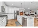 Bright kitchen with stainless steel appliances, white cabinetry, granite countertops, and a central island with pendant lighting at 535 Chalmers Row, Rock Hill, SC 29732