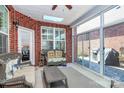 Enclosed brick patio featuring ceiling fan, skylight, glass sliding doors, and comfortable seating at 535 Chalmers Row, Rock Hill, SC 29732