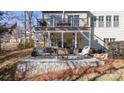 Covered patio with sectional sofa, fire pit, and outdoor TV at 6928 Garden Hill Dr, Huntersville, NC 28078