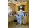 Kitchen with white appliances and yellow cabinets at 815 E Lafayette St, Salisbury, NC 28144