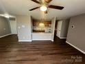 Living room with laminate floors and kitchen passthrough at 9401 Old Concord Rd # K, Charlotte, NC 28213