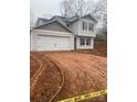 Two-story house with gray siding, attached garage, and a newly landscaped yard at 104 Springdale St, Shelby, NC 28150