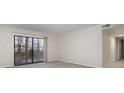 Bright living room featuring carpet flooring and a sliding glass door with access to outdoor space at 133 Orchard Trace Ln # 7, Charlotte, NC 28213