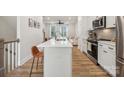 Modern kitchen with island, white cabinets and stainless steel appliances at 330 Simeon Dr, Charlotte, NC 28208