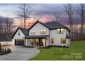 Striking two-story home with a modern aesthetic and a side-entry two-car garage and well kept lawn at 3415 Waxhaw Indian Trail S Rd, Waxhaw, NC 28173