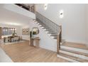 Bright foyer with an open staircase featuring iron railings and wood treads, plus stylish decor at 3415 Waxhaw Indian Trail S Rd, Waxhaw, NC 28173