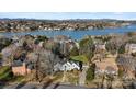 Stunning aerial view of a lakeside home, surrounded by trees and overlooking the serene waters and distant mountains at 430 43Rd Nw Ave, Hickory, NC 28601