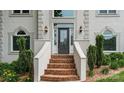Close-up of front door with brick steps and manicured landscaping creating a welcoming entrance at 430 43Rd Nw Ave, Hickory, NC 28601