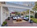 Inviting outdoor patio featuring a pergola, comfortable seating, lush landscaping, and brick pavers, ideal for relaxation at 430 43Rd Nw Ave, Hickory, NC 28601
