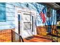 Front entrance with white door, brick base, and American flag at 4745 16Th Street Ne Dr, Hickory, NC 28601