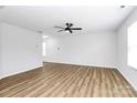 Open living area with light walls and wood-look vinyl flooring at 7214 Fox Point Dr, Charlotte, NC 28269