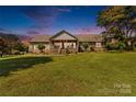 Charming brick home with a large front yard and welcoming covered porch at 795 French Belk Rd, Mt Ulla, NC 28125