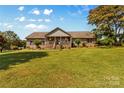 Charming brick home with a large front yard and welcoming covered porch at 795 French Belk Rd, Mt Ulla, NC 28125