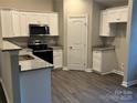 Modern kitchen featuring stainless steel appliances and granite countertops at 1014 N Main St, China Grove, NC 28023