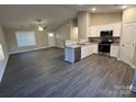 Open living room and kitchen with grey laminate flooring at 1014 N Main St, China Grove, NC 28023