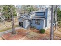Gray house, two-story with a dark garage and steps leading to the entrance at 1061 Woodlake Ln, Tega Cay, SC 29708